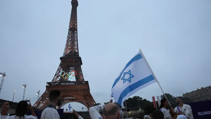 Athletes of Israel look on as the Eiffel Tower is seen from aboard a boat in the floating parade on the river Seine during the Opening Ceremony of the Olympic Games Paris 2024 on July 26, 2024, in Paris, France. (Nir Elias - Pool/Getty Images) (Image obtained at foxnews.com)